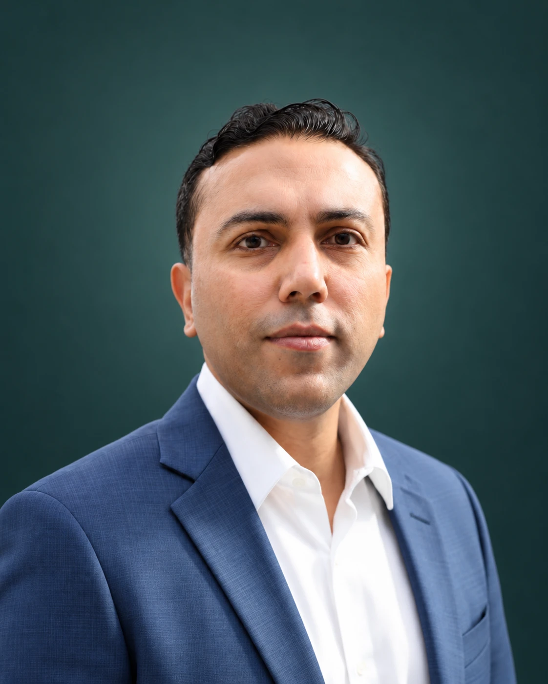Omer Khan wearing a blue blazer and white shirt against a deep teal background